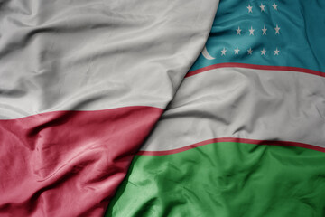 big waving national colorful flag of poland and national flag of uzbekistan .