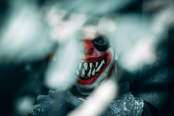 mad evil clown stares at the observer