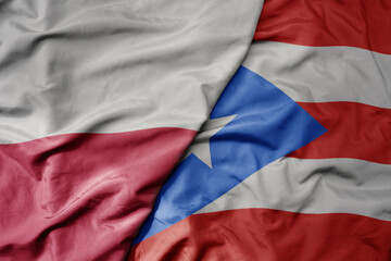 big waving national colorful flag of poland and national flag of puerto rico .