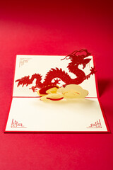 a pop-up greeting card with a dragon at vertical composition