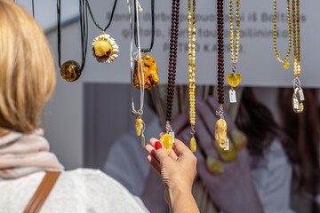 Amber necklaces. Amber of different colors and sizes. Exposition of stones of amber for tourists in a street market