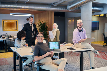 In a modern startup office, a diverse group of young professionals collaboratively tackles various...