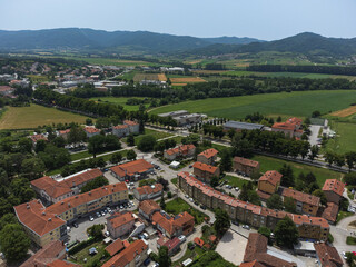 Fototapeta na wymiar Aerial View of Vipava Town, Slovenia. Red Roofs, Fields and Forest Covered Hills in the Background