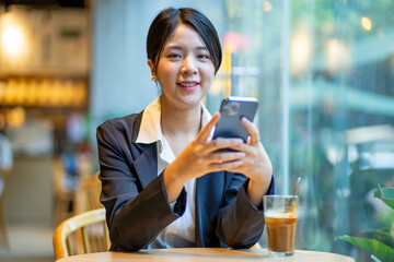 Asian businesswoman sitting and working at a cafe