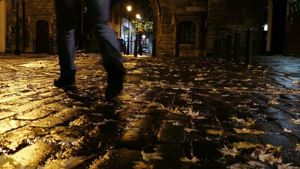 Man Walking Empty Cobbled Street in London at Night
