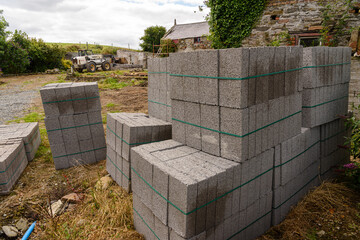 Concrete breeze blocks sit at a building site.