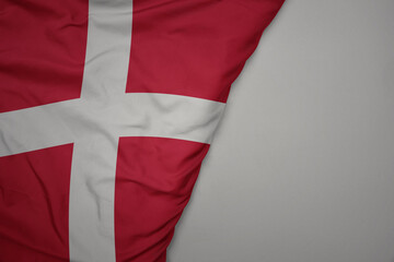 Fototapeta premium big waving national colorful flag of denmark on the gray background.