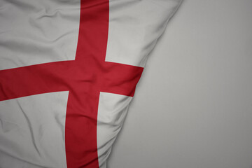 big waving national colorful flag of england on the gray background.