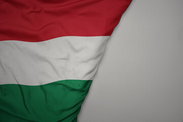 big waving national colorful flag of hungary on the gray background.