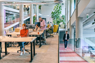 In a modern startup office, a diverse group of young professionals collaboratively tackles various business problems and challenges, surrounded by their engaged colleagues, fostering innovation and