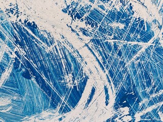 Bright white scratches on a blue surface