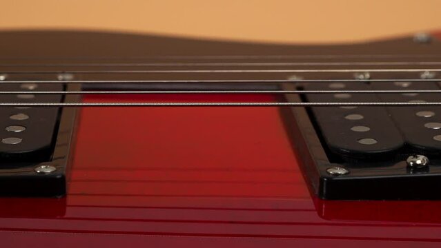 Six-string electric guitar. The camera moves to the rhythm of the guitar. Guitar close-up.