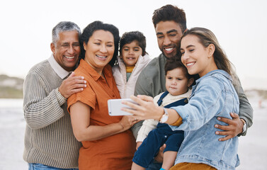 Family, grandparents and children in selfie on beach for holiday, vacation and outdoor on social media. Happy mother, father and senior people with interracial kids in profile picture or photography