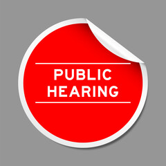 Red color peel sticker label with word public hearing on gray background