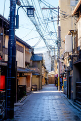 the serene ambiance of a local Japanese alley in Kyoto during the early morning hours.