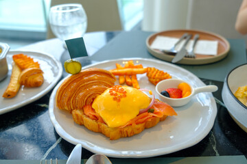 Egg benedict Smoked salmon criossant serve with side dish