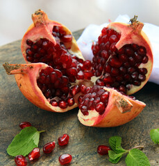 fresh organic pomegranate fruit on wooden board