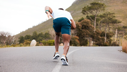 Fitness, race or runner running on road by nature for exercise, training or outdoor workout. Back view, fast black man or active athlete on street with endurance, freedom or sports challenge on hill