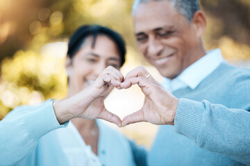Hands, heart and emoji with a senior couple outdoor in celebration of their love or anniversary together. Hope, trust or peace with an elderly man and woman closeup for freedom or romance in summer