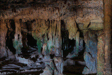 Entrance to Fontein cave, Arikok National Park, Aruba. Stalactites, multi-colored stone formations. 
