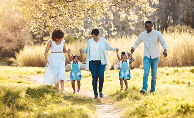 Obraz premium Walking, holding hands and family generations in nature at an outdoor park together for bonding. Love, fun and children with grandmother and parents in a green garden on weekend trip or holiday.