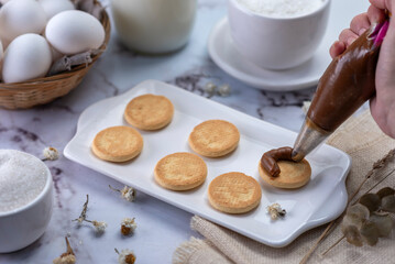 process of assembling tapas and cornstarch alfajores with dulce de leche and coconut with milk eggs sugar everything with white bajilla
