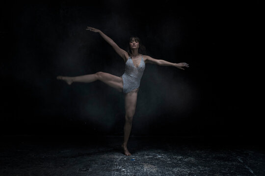 ballet dancer posing. ballet dancer in black. woman dancing in the dark. woman dancing in studio. woman dancing.