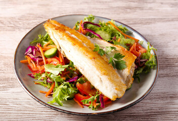 seabass fish fillet over salad