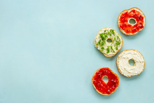 Set of fresh bread bagels with with berry jam and cheese cream. Healthy breakfast