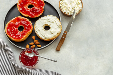 Set of fresh bread bagels with with berry jam and cheese cream. Healthy breakfast