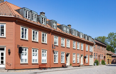 Happy walking in old Fredrikstad on a great warm summer day, with many old buildings, Norway	