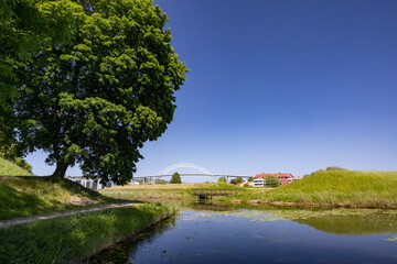 Bridge over the river Glomma- Happy walking in  Fredrikstad city on a great warm summer day, with many old buildings, Norway	