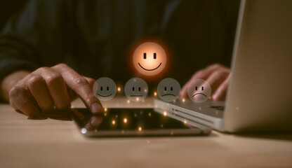 Customer service satisfaction survey concept.Business people or customers show satisfaction by pressing face emoticon smile in satisfaction on virtual touch screen. rating very impressed