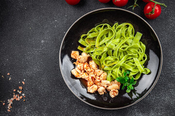 tagliatelle green pasta tomato sauce chicken meat vegetable food meal snack on the table copy space food background rustic top view