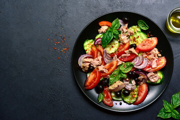 Tuna salad with cucumber and tomato. Top view with copy space.