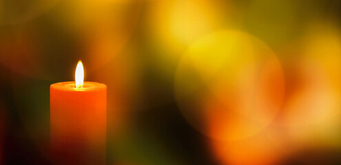 burning red candlelight with geometrical bokeh light background in classical bright christmas...