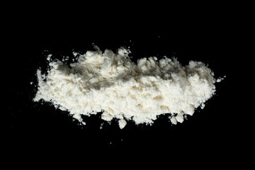 A pile of white powder on a black background. Top view.