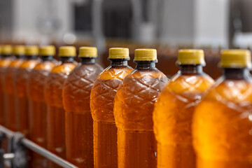 Concept modern production line of brewery industry. Conveyor with brown plastic beer bottles with drink alcohol