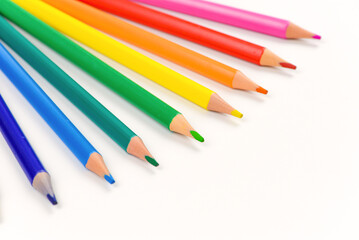Colored pencils individually on a white background. Close-up.