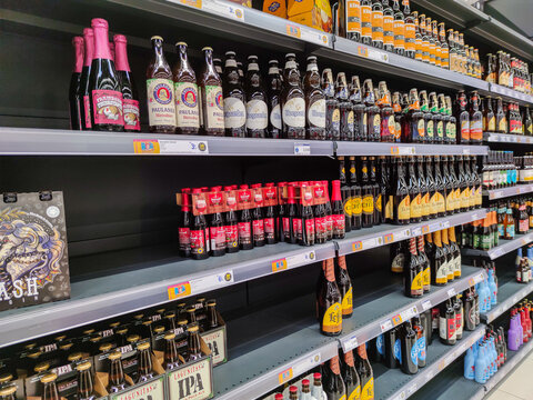 Several brands of Beer Bottles On Supermarket Stand in France Hupermaket