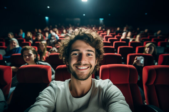 Funny young guy student making selfies at modern cinema premiere Generative AI