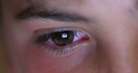 Boy eye staring at tablet screen playing video-game on tech, macro closeup eyes