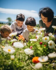 Grandparents having fun with their grandchildren on a spring day among the blooming flowers and grass