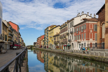 Fototapeta na wymiar Navigli of Milan, Italy, August 8, 2023; A beautiful sight of houses along the canal of Navigli di Milano