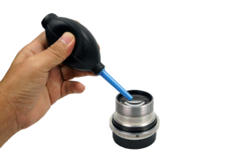 A hand pressing an air blower was cleaning a lense  isolated on white background with clipping path, clening concept, PNG