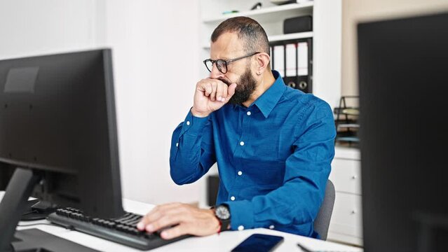Young hispanic man business worker using computer coughing at office