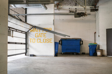 Parking gate damaged in parkade of building. Garage exit of strata building with overhead sectional...