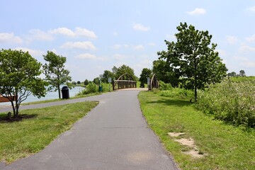 The bridge on the pathway in the park on a sunny day.