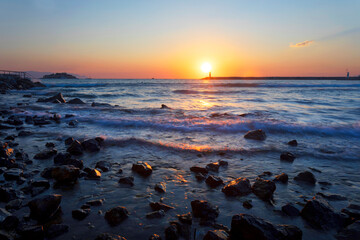 Fototapeta na wymiar Sunset and sea view. Photo taken with the long exposure technique. Turkey Kusadası Beach. 