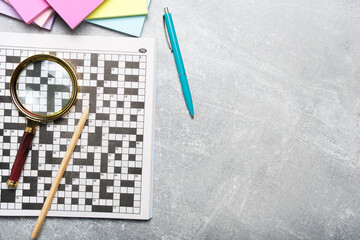 Crossword, magnifying glass and pencil. Set for training mind.